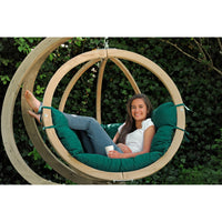 Relaxing, smiling women lying back in hanging egg basket